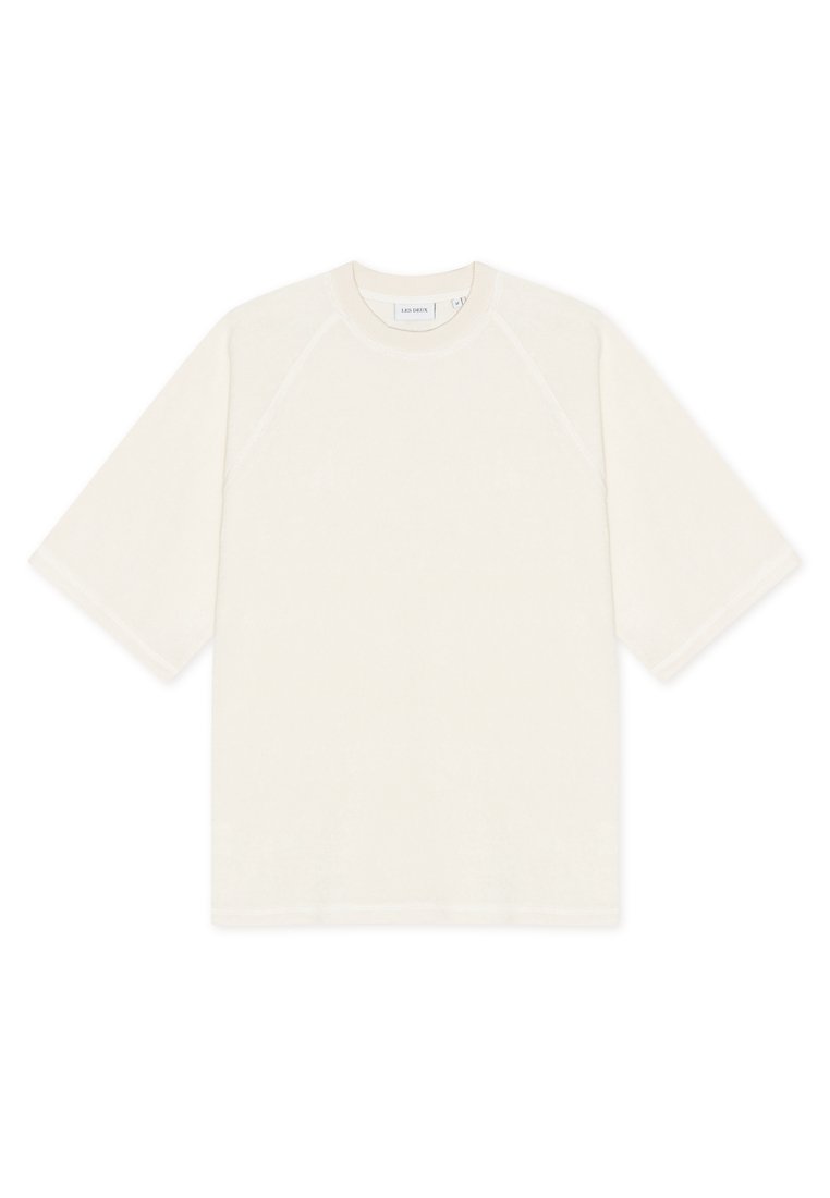 Hellbeiges T-Shirt mit lockerem Schnitt, kurzen Raglanärmeln und Rundhalsausschnitt. Hergestellt aus weichem Stoff, mit minimalistischem Design.