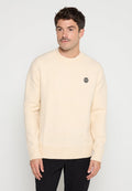Cremfarbener Pullover aus weichem Stoff, mit Rundhalsausschnitt und geripptem Saum. Kleines schwarzes Logo auf der Brust.