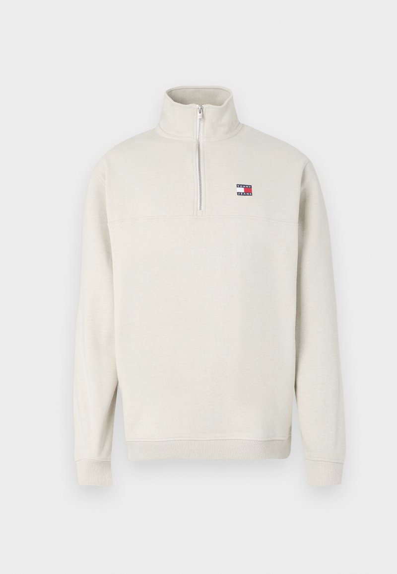 Hellbeige Halb-Zip Sweatshirt aus weichem Stoff. Mit geripptem Kragen und Bündchen, sowie einem kleinen Logopatch auf der Brust.