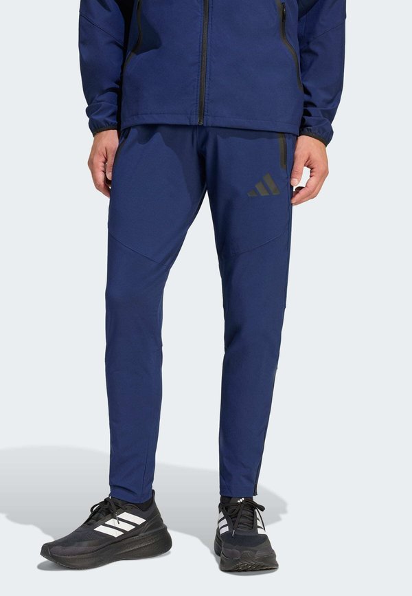 adidas Performance TIRO TRAVEL PANTS - Tracksuit bottoms - team navy blue/black