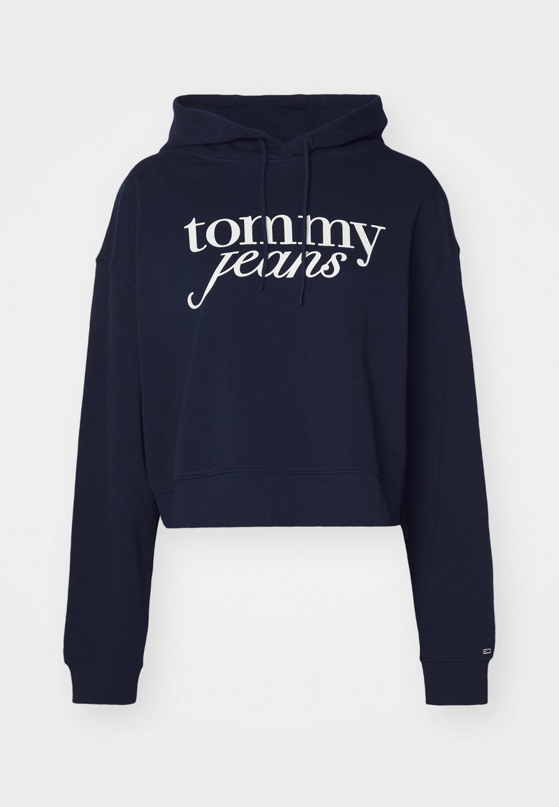 Marineblauer verkürzter Kapuzenpullover aus Baumwolle, mit einem weißen "tommy jeans" Logo, einer Kordelzugkapuze und gerippten Bündchen.