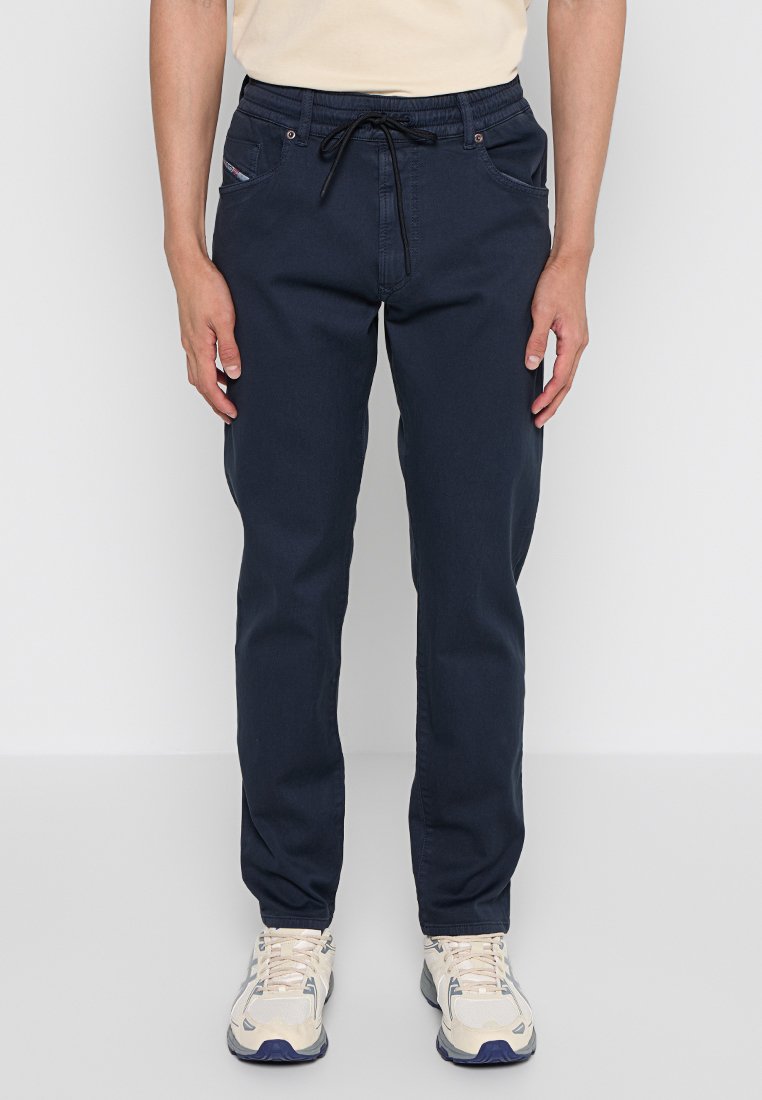 Marineblaue Hosen mit Kordelzugbund, Fronttaschen und schmaler Passform. Aus Baumwollstoff mit glatter Textur, geeignet für legere Outfits.