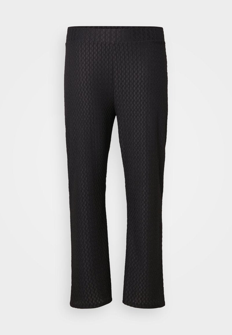 Schwarze Hose mit einem strukturierten Diamantmuster, breitem elastischen Bund und einem lockeren Schnitt. Der Stoff ist leicht und atmungsaktiv.
