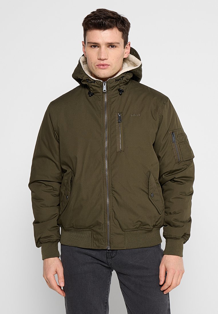 Grüne gepolsterte Jacke mit Reißverschluss, verstellbarem Kapuze, seitlichen Taschen und gerippten Bündchen. Hergestellt aus einem glatten, langlebigen Material.