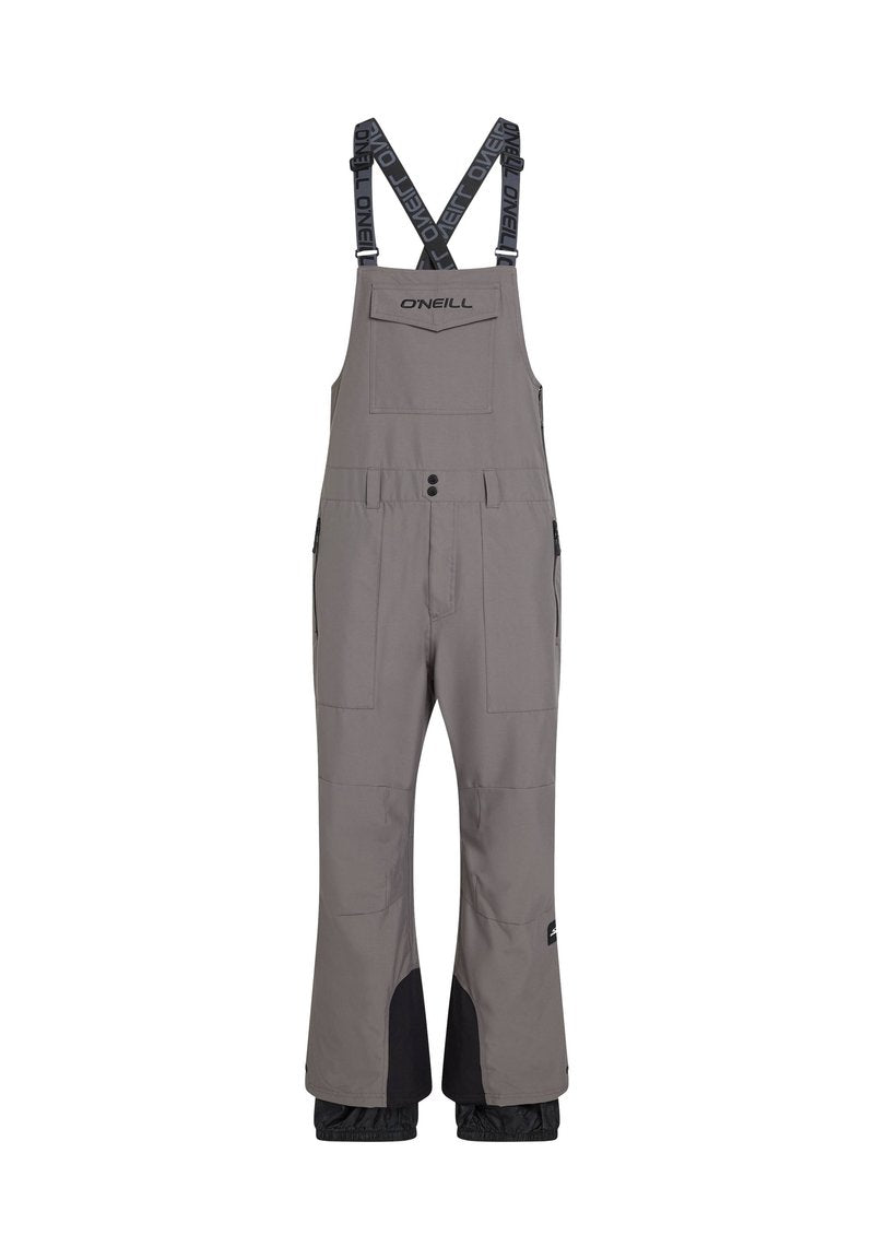 Grau wasserfester Overall mit verstellbaren Trägern, mehreren Taschen, verstärkten Knien und schwarzen Akzenten an den Unterschenkeln. Markenlogo auf der Brust.