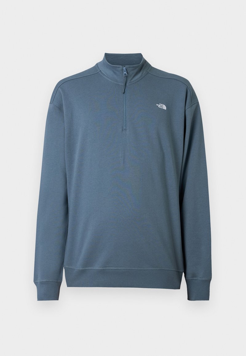 Blauer Langarm-Quarter-Zip-Pullover mit Stehkragen und kleinem weißen The North Face-Logo auf der linken Brust.