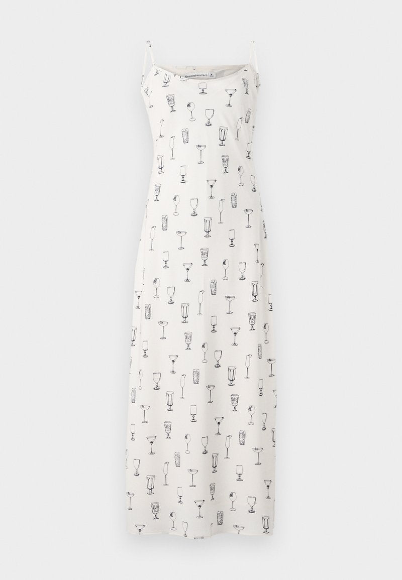 Ärmelloses Maxikleid aus weißem Stoff mit schwarzen Cocktails als Illustrationen. Verfügt über dünne Träger und einen lässigen Schnitt.