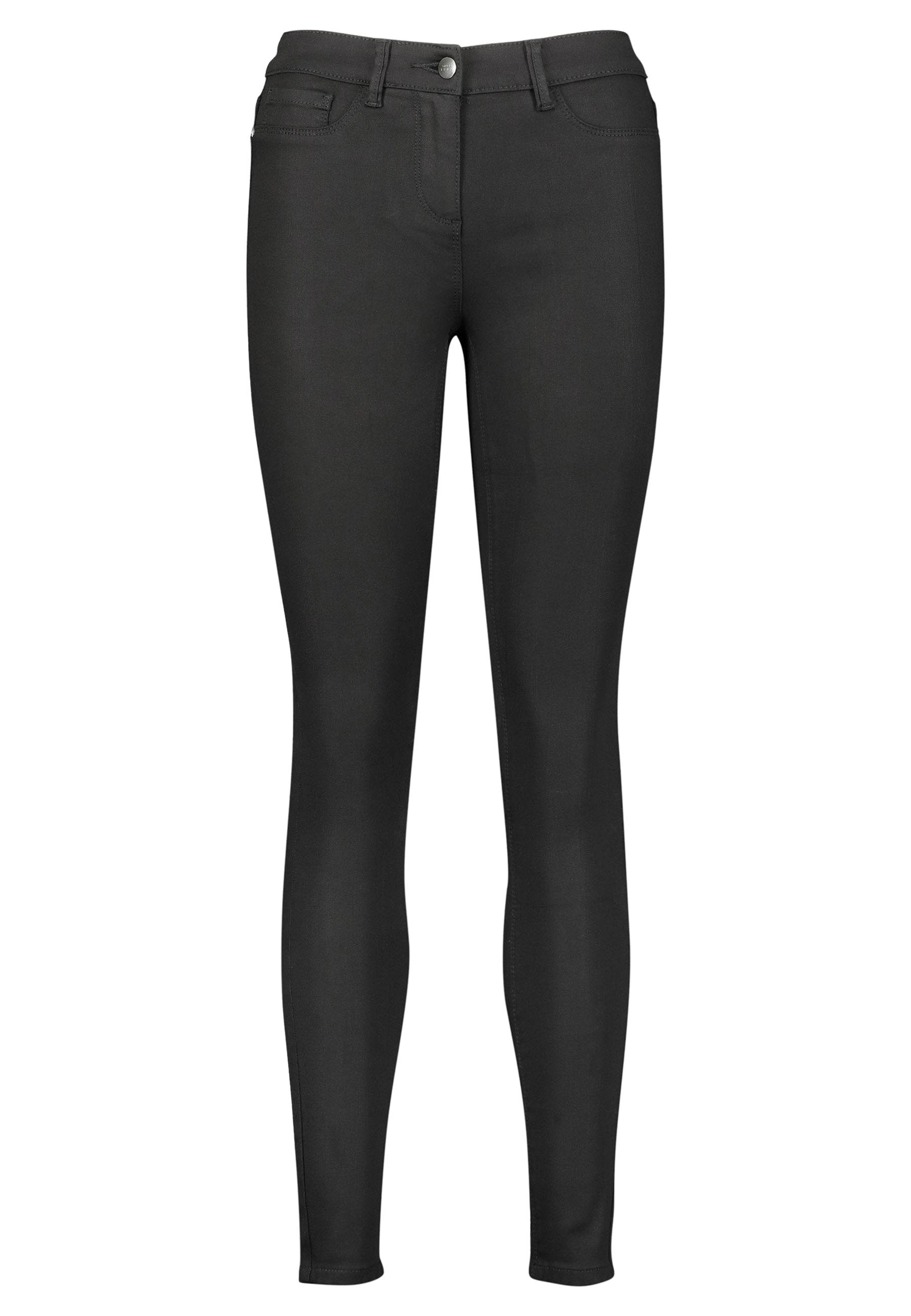 Schwarze Skinny Jeans aus Stretchdenim. Mit Knopfverschluss, Fronttaschen und einer glatten Textur. Figurbetonter Schnitt.