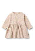 Langärmeliges Kleid aus hellrosa Stoff mit mehrfarbigem Blumenmuster, geraffter Taille und rundem Ausschnitt. Das Etikett zeigt die Marke "WHEAT".