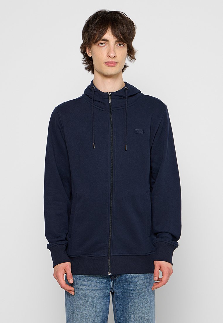 Dunkelblauer Zip-Hoodie aus weichem Stoff, mit einer Kapuze mit Kordelzug, Fronttaschen und gerippten Bündchen und Saum für einen sicheren Sitz.