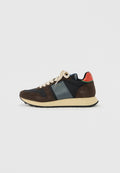 Niedriger Sneaker mit braunem Wildleder, marineblauen und türkisfarbenen Einsätzen, cremefarbenen Schnürsenkeln, beiger Sohle und rotem Fersenriemen vor weißem Hintergrund.