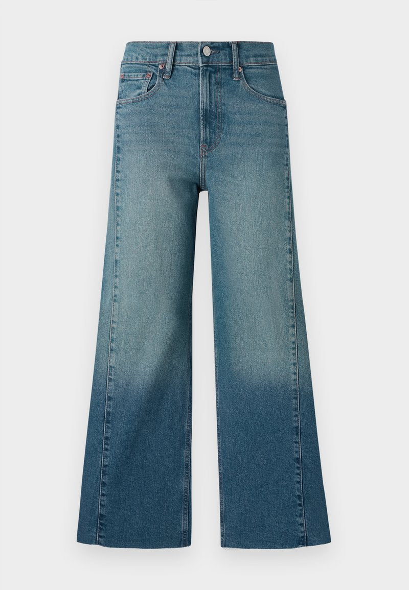 Weite Jeans in einem mittelblauen Waschung, mit einem Farbverlauf von dunkler zu heller. Hergestellt aus Denim mit einem traditionellen Fünf-Taschen-Design.