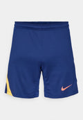 Marineblaue Sportshorts mit gelbem seitlichem Detail und pinkem Nike Swoosh-Logo am rechten Bein, elastischer Bund.