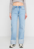 Hellblaue, ausgestellte Jeans mit hoher Taille, rohem Saum an den Bündchen und Fünf-Taschen-Design, getragen mit einem grauen Langarmoberteil.