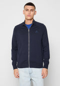 Marineblauer Reißverschluss-Pullover aus weichem Stoff, mit hohem Kragen und dezentem Branding. Eng anliegend, mit gerippten Bündchen und Saum.