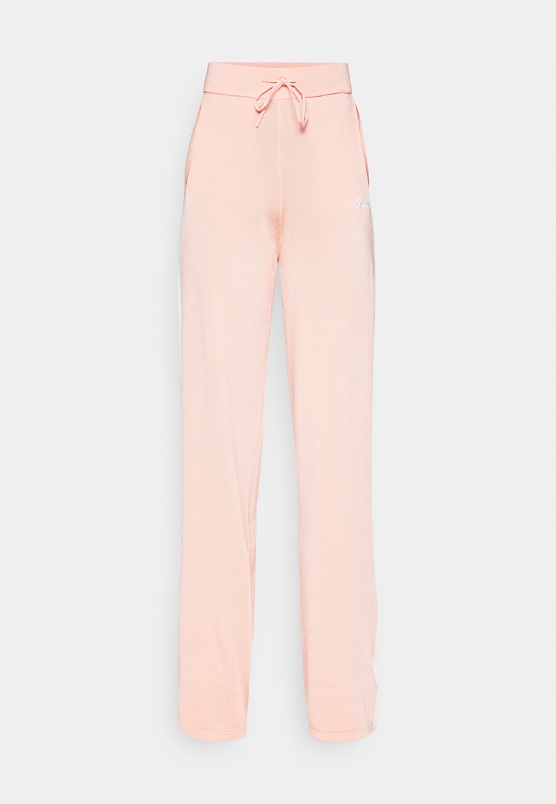 Pfirsichfarbene Sweatpants aus weichem Material, mit einem Kordelzugbund, seitlichen Taschen und einem schlichten Logo auf der linken Seite.