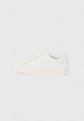Weißer Sneaker mit niedrigem Schnitt, goldenen Ösen, weißen Schnürsenkeln und einem dezenten, geprägten Logo an der Seite, von der Außenseite gezeigt.