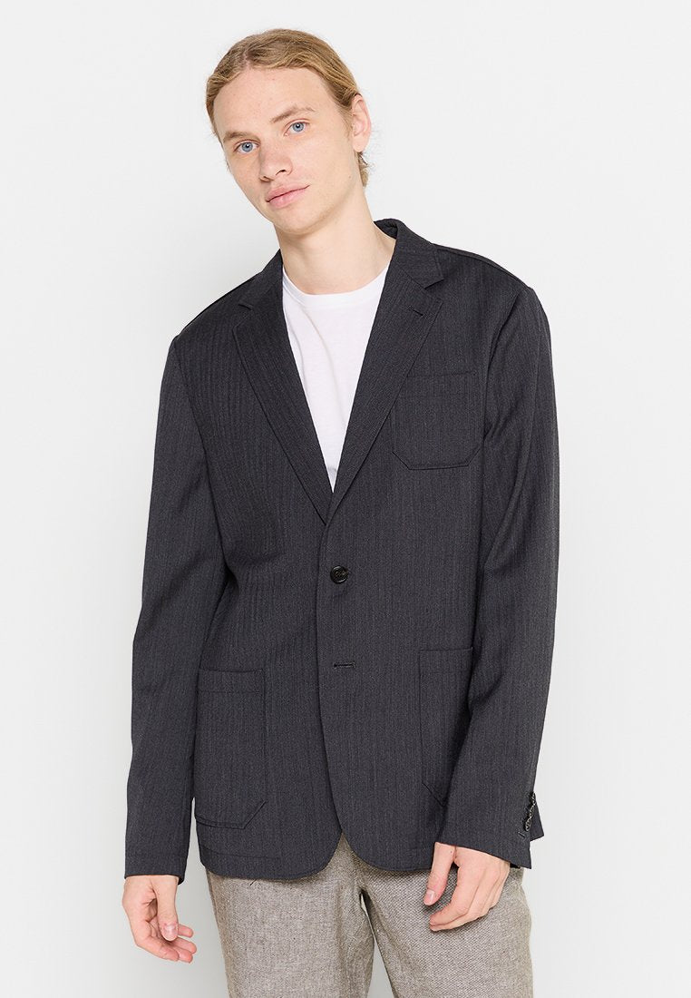Dunkelgraues gestreiftes Sakko mit zwei vorderen Taschen, einer Ein-Knopf-Verschluss und Reverskragen. Schmale Passform und aus einem glatten Stoff gefertigt.