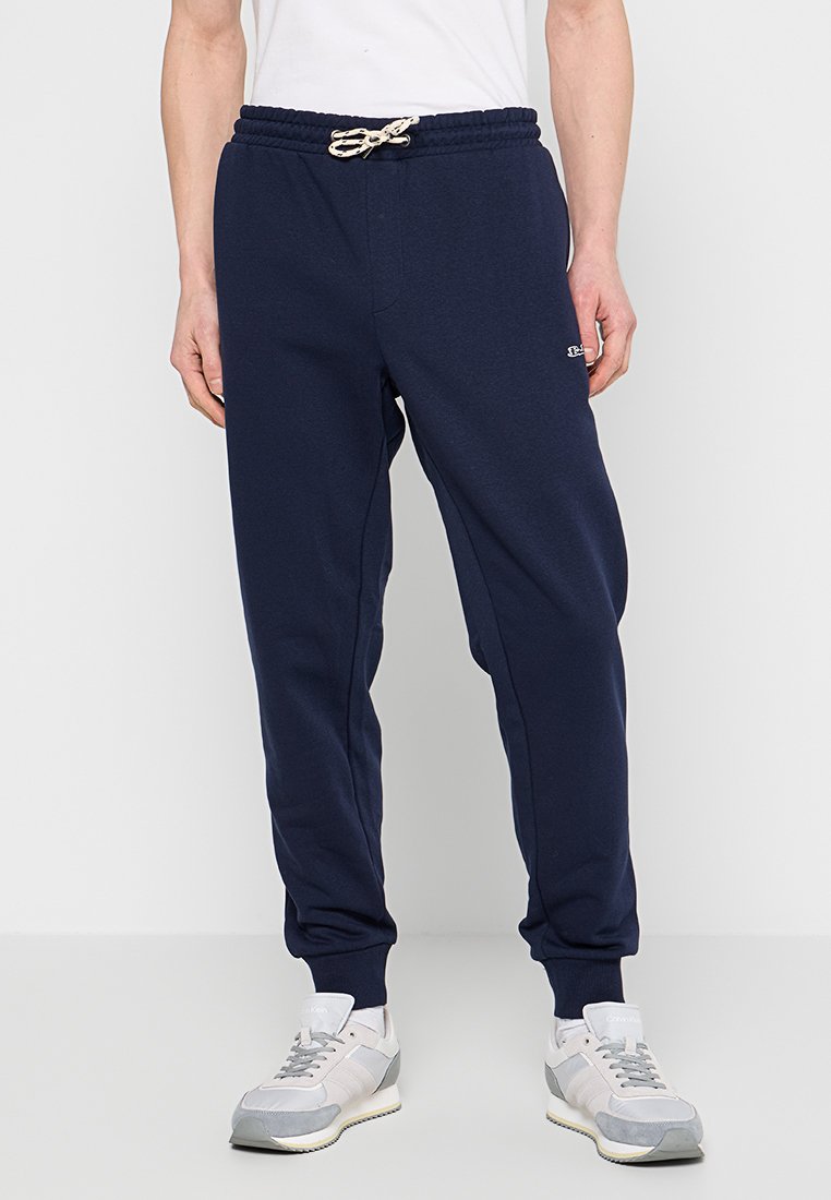 Navyblaue Jogginghosen aus weichem Material mit elastischem Bund und Kordelzug. Mit Seitentaschen und gerippten Bündchen an den Knöcheln.