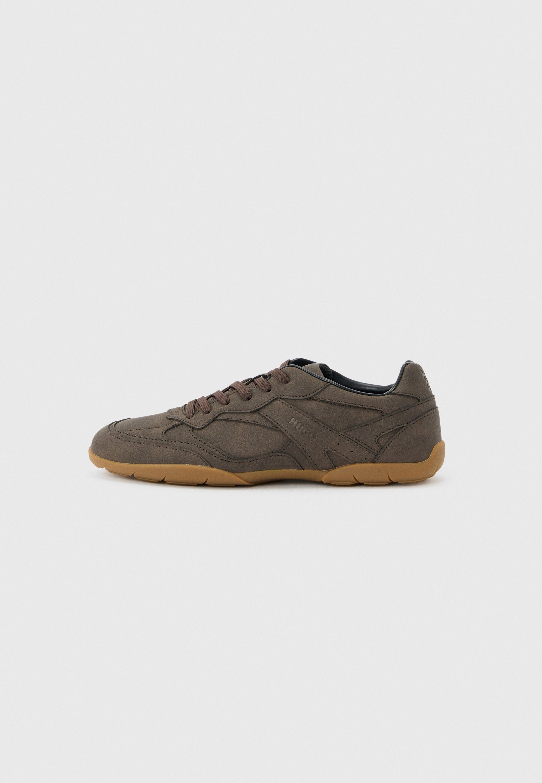 Brauner Sneaker in Wildleder- und Lederoptik mit niedrigem Schnitt, Kautschuksohle, Schnürverschluss, seitlichen Ziernähten und dezentem Markenprägung.