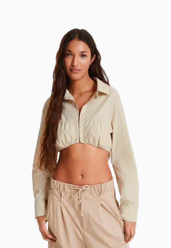Bershka LONG SLEEVE AND GATHERED DETAIL AT THE FRONT WITH STOPPER