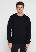 Schwarzer Strickpullover mit Rundhalsausschnitt, gerippten Bündchen und einem kleinen gestickten Design auf der Brust. Strukturiertes Material und lässige Passform.