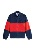 Marineblaue und rote Trainerjacke mit Druckknöpfen, elastischen Bündchen und kleinem Tommy Jeans-Logo auf der linken Brust.