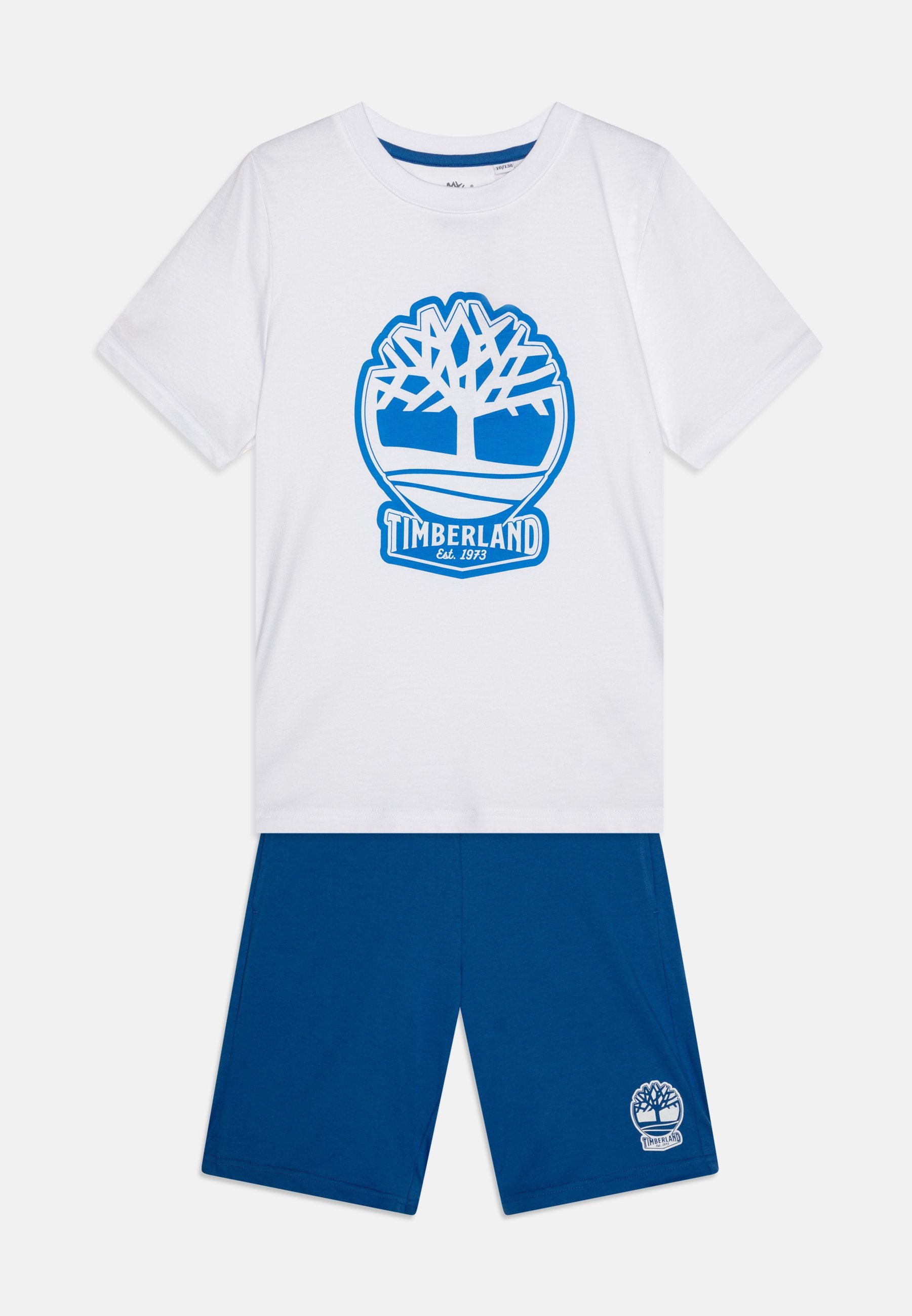 Weißes Baumwoll-T-Shirt mit blauem Timberland-Baum-Logo und Text, kombiniert mit blauen Shorts mit kleinem Logo. Glatte Textur, lässiges Design.