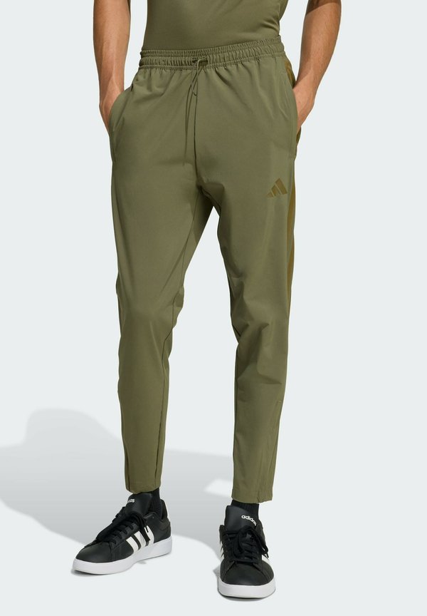 adidas Sportswear HOUSE OF TIRO - Tracksuit bottoms - olive strata colored reflective