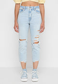 Hellblaue Jeans mit zerstörten Knien, ausgefranstem Saum und lockerer Passform. Kombiniert mit hellblauen High-Top-Sneakern.
