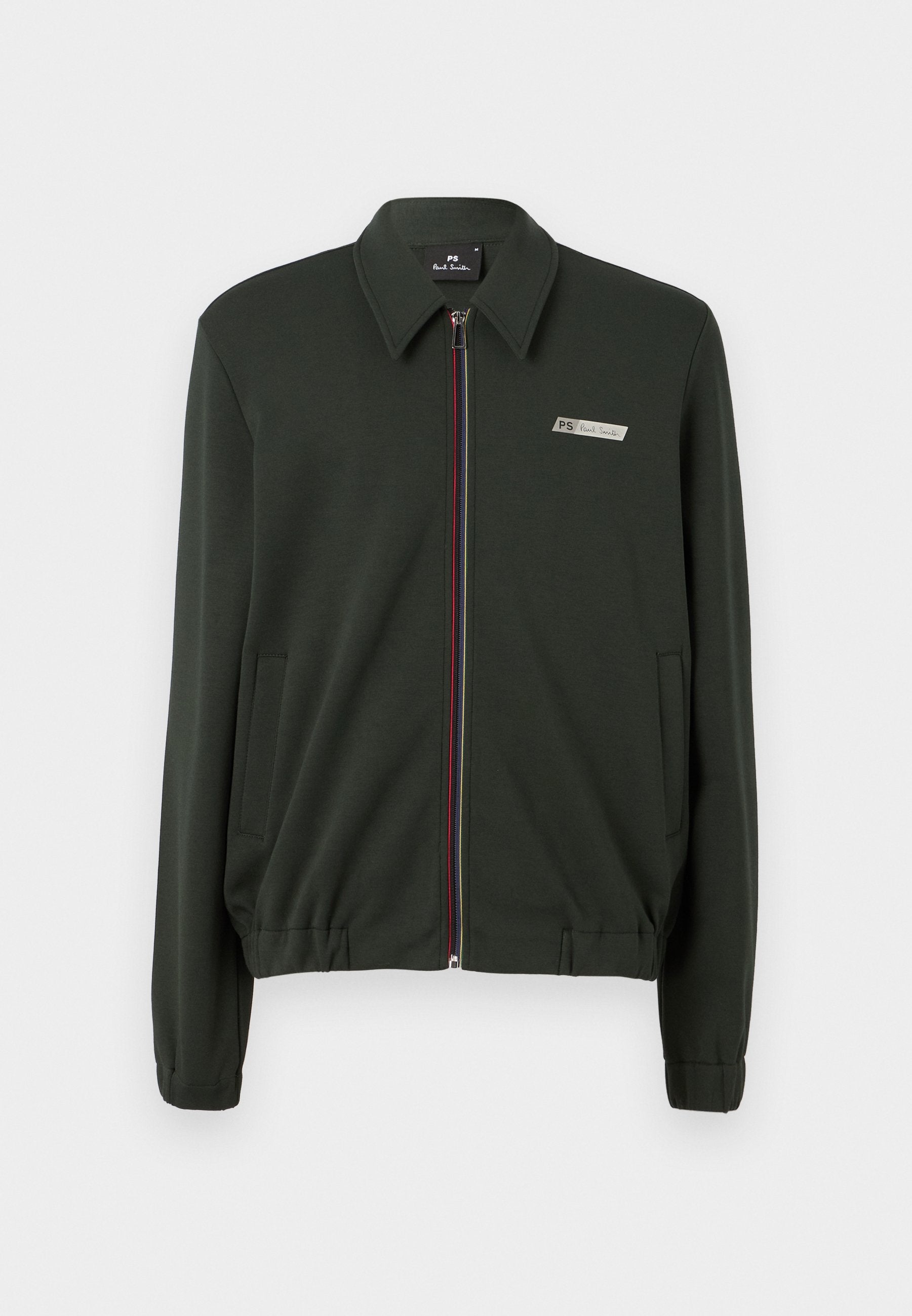 Dunkelgrüne Zip-Jacke aus glattem Stoff, mit Kragen, zwei seitlichen Taschen und mehrfarbigen Reißverschlussakzenten.